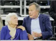  ?? DAVID J. PHILLIP — THE ASSOCIATED PRESS FILE ?? In this file photo, former President George H.W. Bush and his wife Barbara Bush, left, speak before a college basketball regional final game between Gonzaga and Duke, in the NCAA basketball tournament in Houston. A family spokesman said Sunday that the...