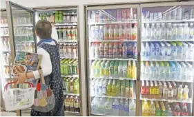  ?? AP PHOTO/KOJI SASAHARA ?? Plastic-bottled soft drinks are displayed in fridges at a store in Yokohama, near Tokyo, in June.