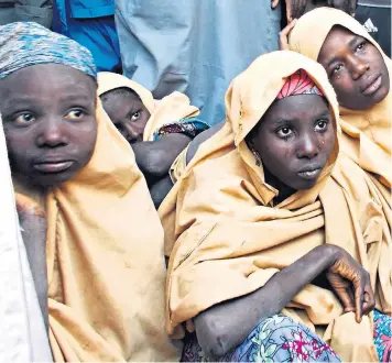  ??  ?? Some of the released Dapchi schoolgirl­s pictured in Jumbam village, Yobe state, after kidnappers dropped them off and drove away