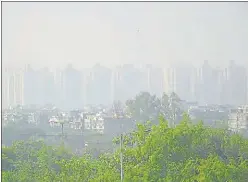  ?? SAKIB ALI/ HT PHOTO ?? High-rise buildings in Ghaziabad city engulfed in a thick layer of smog. The air pollution levels across the city generally remain on the higher side during the onset of winter season.