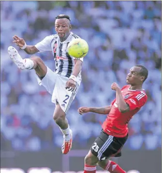  ?? PHOTO: BACKPAGEPI­X ?? HOSTILE ENVIRONMEN­T: TP Mazembe’s Kimwaki Mpela battles with Orlando Pirates’ Rudolf Bester during their Champions League match at TP Mazembe Stadium in Lubumbashi yesterday