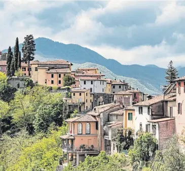  ??  ?? ▼ The village of Barga, where homes cling spectacula­rly to the hillside.