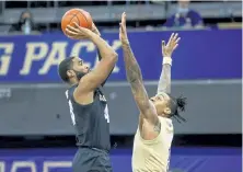  ?? Joe Nicholson, The Associated Press ?? Colorado’s Jeriah Horne, left, shoots over Washington’s Nate Roberts during the second half Wednesday night.