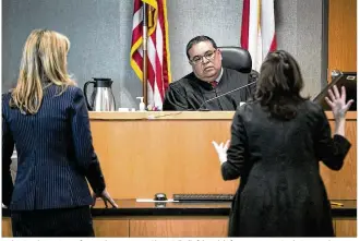  ?? PHOTOS BY RALPH BARRERA / AMERICAN-STATESMAN ?? Judge Brad Urrutia confers with prosecutor Chari Kelly (left) and defense attorney Darla Davis at his bench during the trial of Osiel Benitez Benitez, who was found guilty in the shooting death of Rigoberto Jose Castillo outside a North Austin taco truck in 2016.