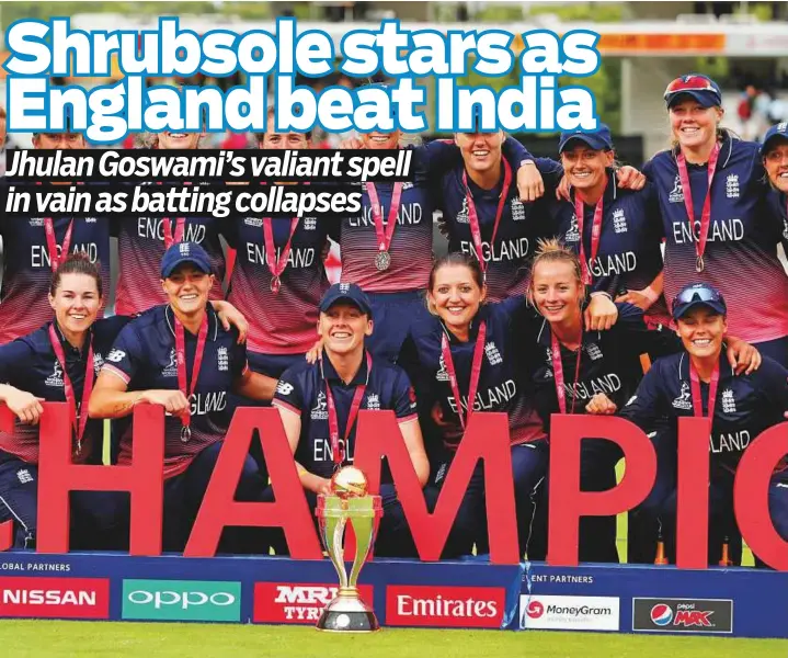  ?? Reuters ?? England players pose for a photograph with their medals and the trophy after winning the Women’s World Cup final at Lord’s yesterday.