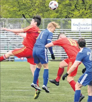  ?? KEITH GOSSE/THE TELEGRAM ?? Holy Cross players (in red) and Paradise opponents go airborne for the ball during Challenge Cup provincial senior men’s soccer play Saturday at King George V Park in St. John’s. Holy Cross won 1-0.