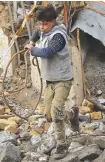  ?? A boy collects scrap metal in Mosul, Iraq. ??
