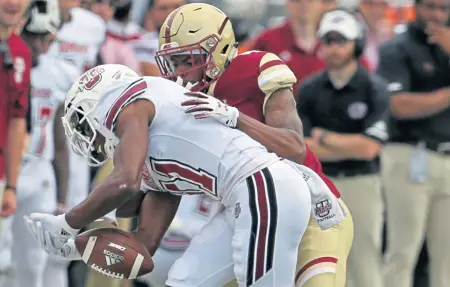  ?? STUART CAHILL / BOSTON HERALD ?? NOT ON MY WATCH: Boston College cornerback Hamp Cheevers knocks the ball out of the hands of UMass wide receiver Zak Simon (11) during the in-state rivals’ matchup at Alumni Stadium on Sept. 1.