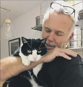  ??  ?? PRECIOUS ‘tuxedo’ cat Boo is reunited with Martin Kingston