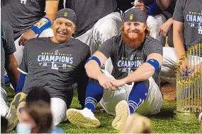  ?? ERIC GAY/ASSOCIATED PRESS FILE ?? Los Angeles’ Justin Turner, right, poses for a World Series photo next to manager Dave Roberts after the Dodgers beat Tampa Bay on Oct. 27.