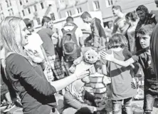  ?? NICOLAS ARMER, EUROPEAN PRESSPHOTO AGENCY ?? A boy accepts a teddy bear at the train station in Munich.