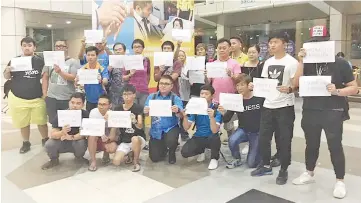  ??  ?? Sabah tour guides staging a protest against the China tour guides at the Kota Kinabalu Internatio­nal Airport just after midnight on July 15.