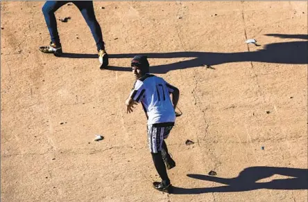  ?? John Moore Getty Images ?? PEOPLE RUN to cross the Rio Grande to get into El Paso from Juarez, Mexico. President Biden met with immigratio­n agents and humanitari­an aid workers in El Paso, where shelters are full and many migrants have resorted to sleeping on the streets in the cold weather.