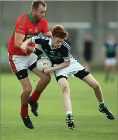  ??  ?? Darragh Rochford of Bray Emmets is challenged by Rathnew’s James Stafford.