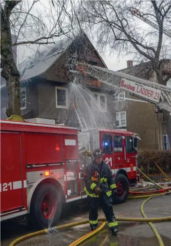  ?? JIM MAHONEY / HERALD STAFF PHOTOS ?? FIVE ALARMS: Boston firefighte­rs battle a stubborn blaze Tuesday on Perrin Street in Roxbury that destroyed a two-family home. At right, Boston fire Commission­er Joe Finn surveys the ice-covered scene.