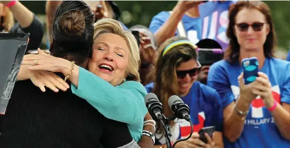  ?? PEDRO PORTAL/TRIBUNE NEWS SERVICE ?? Hillary Clinton hugs Sybrina Fulton, mother of Trayvon Martin (slain in a controvers­ial shooting in Florida in 2012), during a campaign rally in Pembroke Pines, Fla., Saturday.