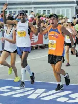  ?? CHRISTINE HOCHKEPPEL/THE CAPE COD TIMES VIA AP ?? After the Boston Marathon is over each year, and workers are sweeping up the confetti, race director Dave McGillivra­y, right, has quietly stolen away to the start line and run the entire Marathon course in the dark. On Monday, he will run it for the...