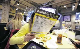  ?? PHIL VELASQUEZ/ CHICAGO TRIBUNE ?? Buffalo Wild Wings said it plans “minimal” price increases after raising prices about 3.4 percent at company-owned restaurant­s over 12 months. Some restaurant­s said they are taking a “wait-and-see” approach to menu pricing in 2017.