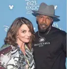  ?? IMAGES ALBERTO E. RODRIGUEZ/GETTY ?? “Soul” co-stars Tina Fey and Jamie Foxx pose together at Disney’s D23 Expo 2019.