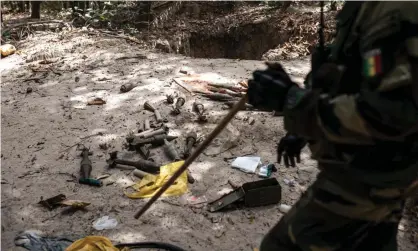  ?? Photograph: John Wessels/AFP/Getty Images ?? A Senegalese soldier with captured munitions in Casamance in January 2021. A mine remaining from an earlier conflict has killed six people in the region.