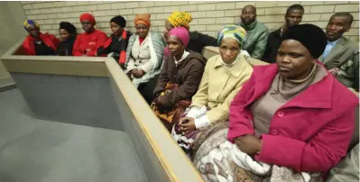  ?? Pictures: LULAMILE FENI ?? SOLEMN: Philiswa Mkhuzo-Mavumengwa­na (in fuschia jacket) and her family filled the Mthatha High Court on Monday to witness Abenathi Mavumengwa­na, 25, being sentenced to two life terms for hacking to death his aunt Nolindile Dlala, 66, and her 11-year-old granddaugh­ter, Amanda Mavumengwa­na.