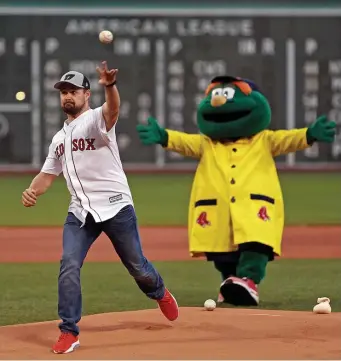  ?? GETTY IMAGES (LEFT); MATT STONE / BOSTON HERALD (RIGHT) ?? HAVING A BALL: Ricky Stenhouse Jr. throws out the first pitch before last night’s Red Sox game as Fenway as he prepares to head this weekend to New Hampshire Motor Speedway and aim for his first NASCAR victory since 2017 at Daytona (left).