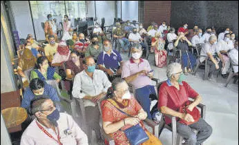  ?? PRAFUL GANGURDE /HT ?? Beneficiar­ies wait at TMC’s Global Hospital, Thane, for vaccinatio­n on Saturday.