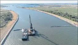  ?? ANDREW INNERARITY — CALIFORNIA DEPARTMENT OF WATER RESOURCES ?? Constructi­on crews build an emergency drought barrier at False River in the Sacramento-San Joaquin Delta in Contra Costa County on June 15.