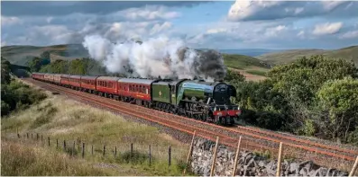  ?? JOHN COOPER-SMITH ?? Popular ‘Pacific’ performer: Flying Scotsman hurries south through the dramatic scenery surroundin­g the Settle-Carlisle line with the Railway Touring Company’s ‘Waverley’ on July 7.