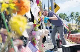  ?? LYNNE SLADKY/AP ?? Michael Knoll, chief curator of the HistoryMia­mi Museum, works Aug. 30 at the site of a memorial wall honoring the victims of the building collapse on June 24 that killed 98 people in Surfside.