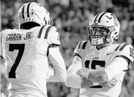  ?? SEAN GARDNER/GETTY IMAGES ?? LSU’s D.J. Chark, left, Danny Etling and their teammates return to Orlando for another Citrus Bowl. The Tigers routed Louisville 29-9 in last season’s Citrus Bowl.