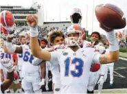  ?? AP PHOTO/MARK HUMPHREY ?? Florida quarterbac­k Feleipe Franks (13) celebrates with teammates after last Saturday’s 37-27 win at Vanderbilt, which gave the Gators a 6-1 record enting next week’s rivalry game against Georgia.