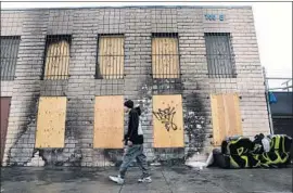  ??  ?? A BUILDING on 7th Street bears the scars from a fire started in a homeless encampment. More than 4,600 homeless people live on skid row.