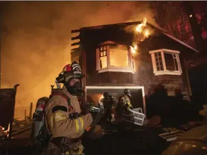  ?? ANDA CHU — STAFF ARCHIVES ?? Firefighte­rs remove items from a garage after a wildland fire ignited a home along Tucker Road in Calistoga in October 2020. With a spate of wildfires occurring in Northern California in recent years, homeowners have had a difficult time getting affordabe insurance as many insurers also have opted to quit writing policies because of the risks.