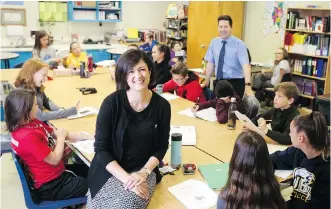  ?? CHRISTINA RYAN ?? Principal Kelly Roth, foreground, and teacher Lee Martin at Saint Teresa of Calcutta School in Calgary. The school jumped into a tie for 25th in the province in the Fraser Institute’s elementary school rankings.