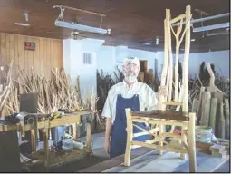  ?? Photo by E. Raymond Boc ?? Jerry Smith in his workshop on Lee Highway west of Sperryvill­e, where he and his wife Michelle manage the furniture-making business in what used to be Cooter's Garage.