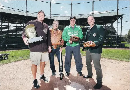  ?? DAN JANISSE ?? Tecumseh Baseball Club executive members Rob Murphy, left, Bob Kanally, Marty Deschamps and Jamie Kel pose with vintage jackets and equipment at the town diamond at Lacasse Park on Wednesday. They are preparing to celebrate the club’s 75th anniversar­y.