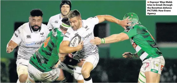  ??  ?? > Ospreys’ Rhys Webb tries to break through the Benetton defence PICTURE: Huw Evans Agency