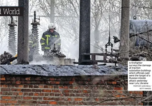  ?? PHOTO BY LEON NEAL/ GETTY IMAGES ?? A firefighte­r surveys the damage at traction substation buildings which officials said were the target of a Russian missile attack yesterday near Lviv, Ukraine