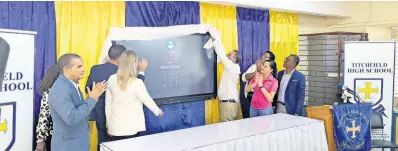  ?? PHOTO BY GARETH DAVIS SR ?? Technology and science minister Daryl Vaz, along with other dignitarie­s, unveils the smartboard at Titchfield High School.