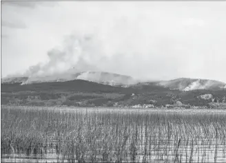  ?? CP PHOTO ?? The Shovel Lake wildfire burns on a mountain above Fraser Lake near Fort Fraser, B.C., last month