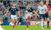  ??  ?? Kenny Miller scores for Scotland against England at Wembley in 2013