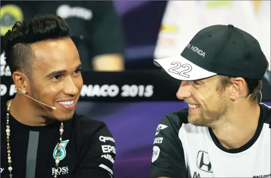  ?? Picture: PAUL GILHAM, GETTY IMAGES ?? LIKE MY DO, JENSON? Lewis Hamilton and Jenson Button share a light moment during the drivers press conference in Monaco yesterday.