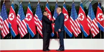  ?? — AP ?? President Donald Trump shakes hands with North Korean leader Kim Jong- un during their meet on Sentosa Island, Singapore, on Tuesday.