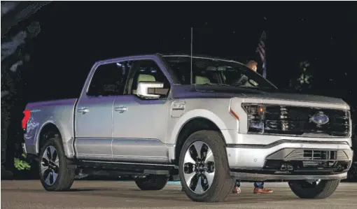  ?? JEFF KOWALSKY/AFP VIA GETTY IMAGES ?? Ford unveils its new electric F-150 Lightning in Dearborn, Michigan, last week.