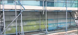  ??  ?? ■ Conservati­on work in removing the moss at the base of Loughborou­gh Carillon Tower has revealed a striking blue tinge which has seeped through rainwater down into the white stones.