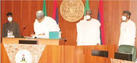  ?? PHOTO: Felix Onigbinde ?? President Muhammadu Buhari (2ND L) flanked by Vice President Yemi Osinbajo (L); Senate President Ahmed Lawan (2nd) and Speaker, House of Representa­tives, Femi Gbajabiami­la while signing the Reviewed 2020 Appropriat­ion Bill into Law at the Council Chambers Presidenti­al Villa in Abuja yesterday.