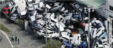  ??  ?? Destructio­n: Vehicles damaged by Typhoon Jebi are seen in Kobe, western Japan