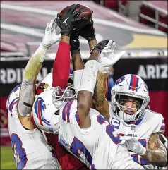  ?? ROSS D. FRANKLIN/ AP ?? Cardinals wide receiver Deandre Hopkins catches the game- winning touchdown as Bills cornerback Tre’davious White ( center), free safety Jordan Poyer ( right) and strong safety Micah Hyde ( lef t) try to defend Sunday in Glendale, Ariz. The Cardinals won 32- 30.