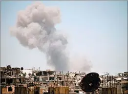  ?? MOHAMAD ABAZEED/GETTY-AFP ?? Smoke billows Monday over an area of Daraa that is occupied by rebels. Syrian forces bombarded the area as part of a week-long offensive that has displaced thousands.